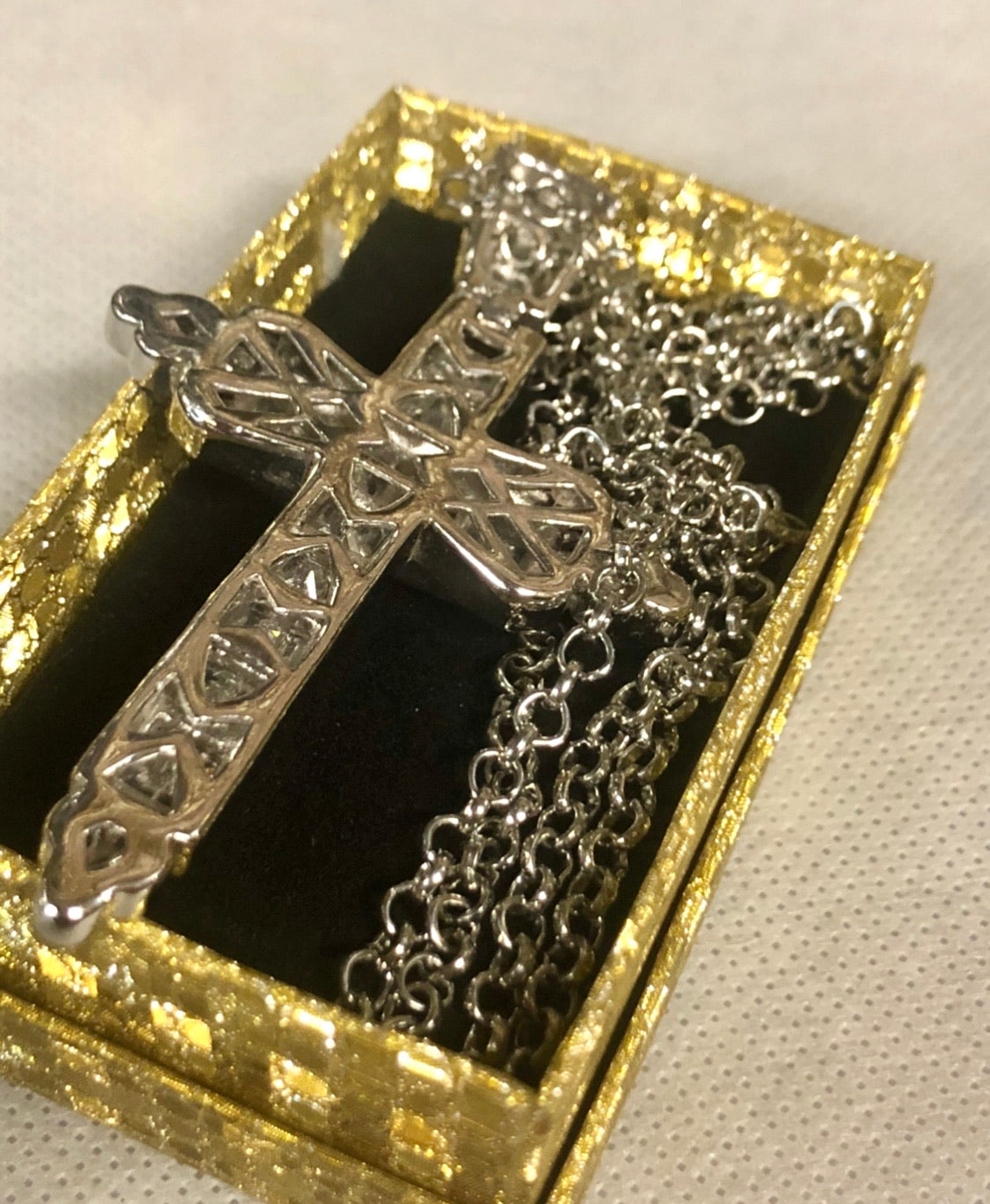 A 925 silver cross pendant with a silver necklace.