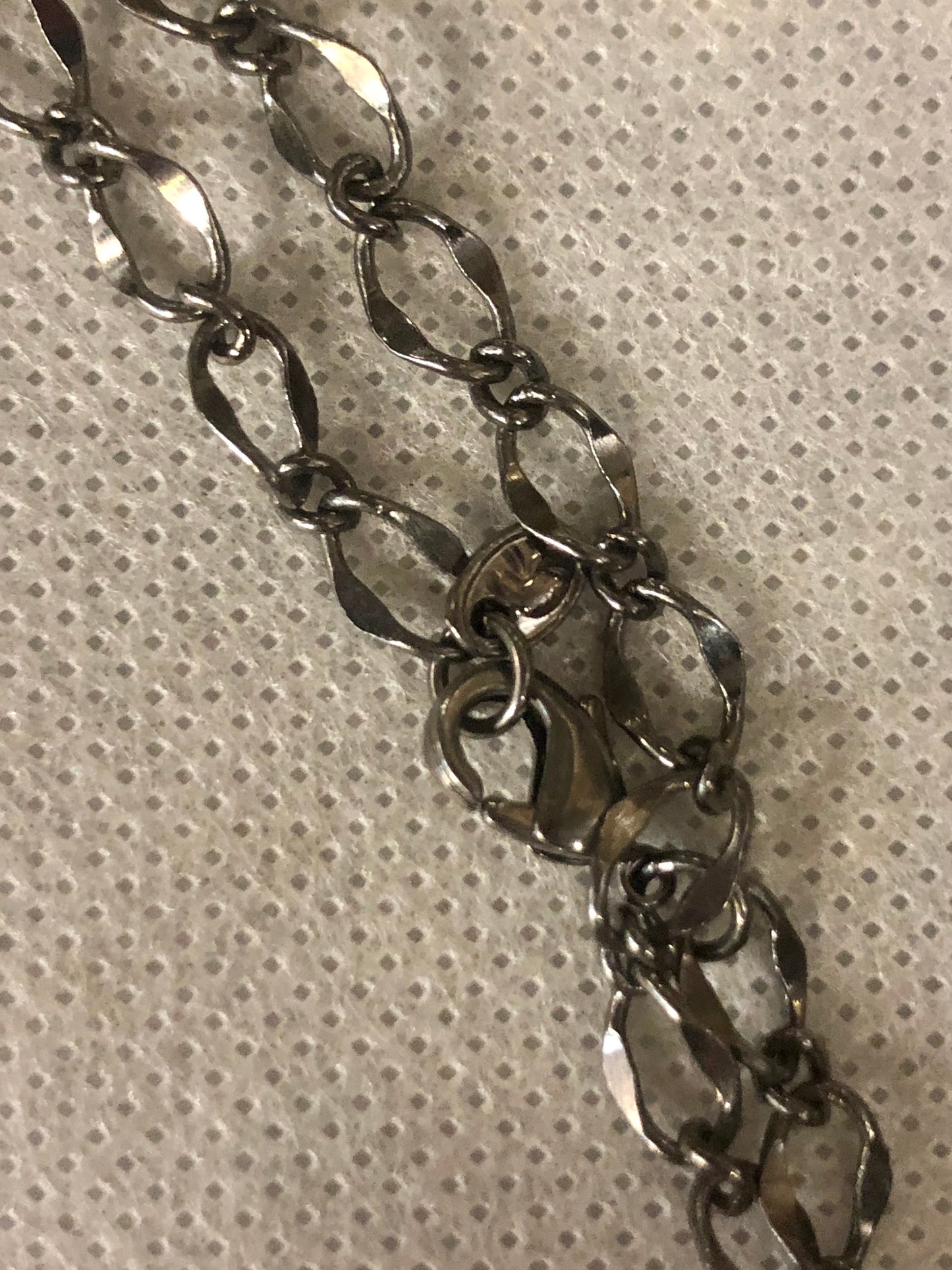 A 925 silver cross pendant with a silver chain.