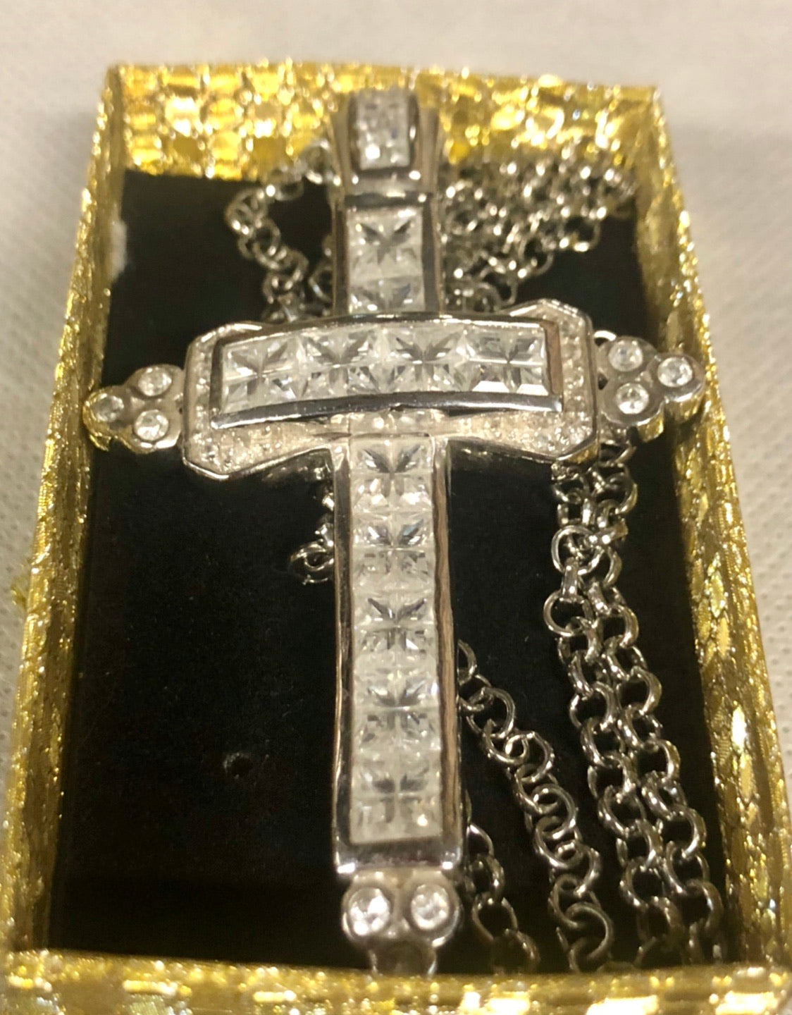 A 925 silver cross pendant with a silver necklace.