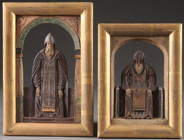 A PAIR OF CARVED RELIEF WOOD RUSSIAN ICONS OF SAINT NIL, 19TH CENTURY.