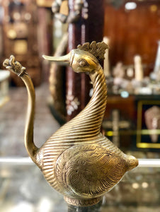 A Golden Bronze Jog displayed in the shape of a Goose. Handmade Bronze Item.