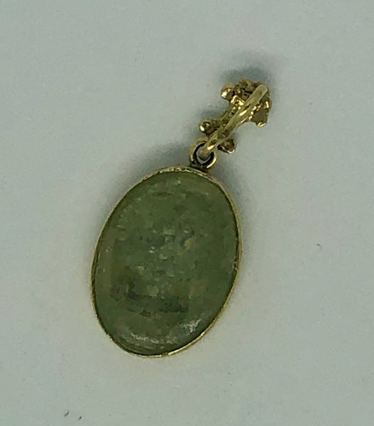 A Roman Glass Pendant with a golden Cross placed carefully on the glass, 14k.