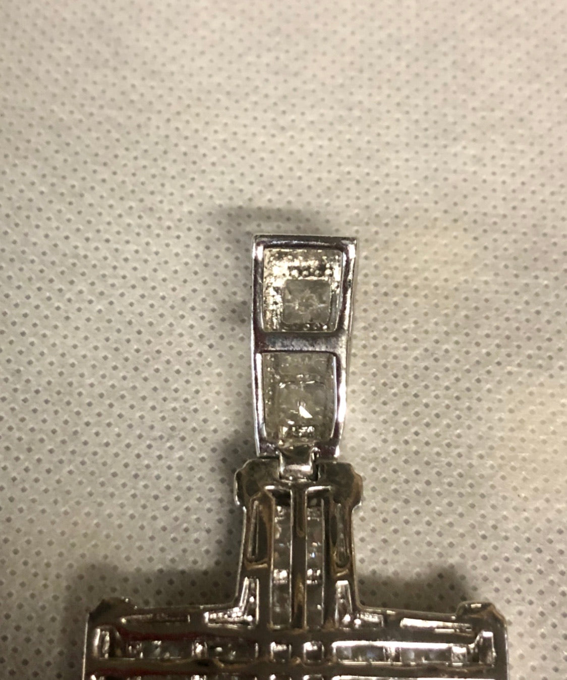 A 925 silver cross pendant with diamonds.