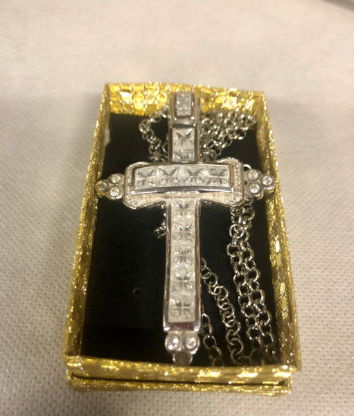 A 925 silver cross pendant with a silver necklace.